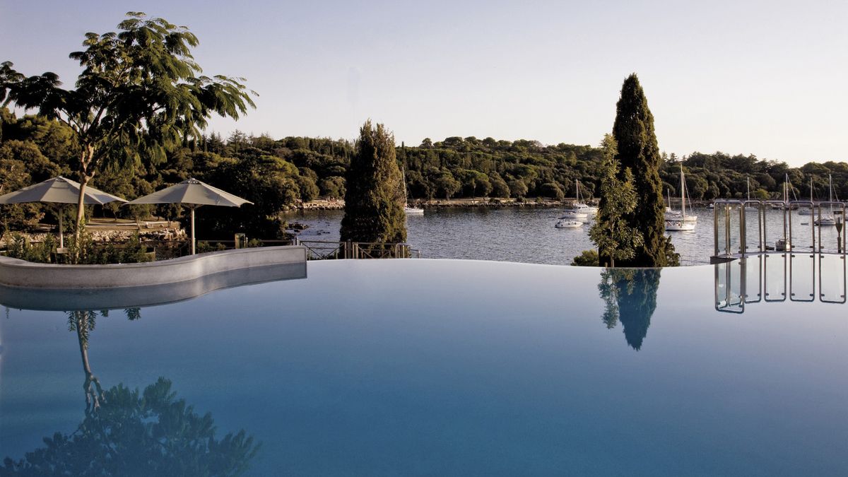 Infinity pool overlooking a Nordic archipelago at dusk